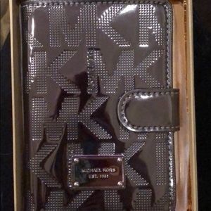 Michael Kors silver metallic passport holder.